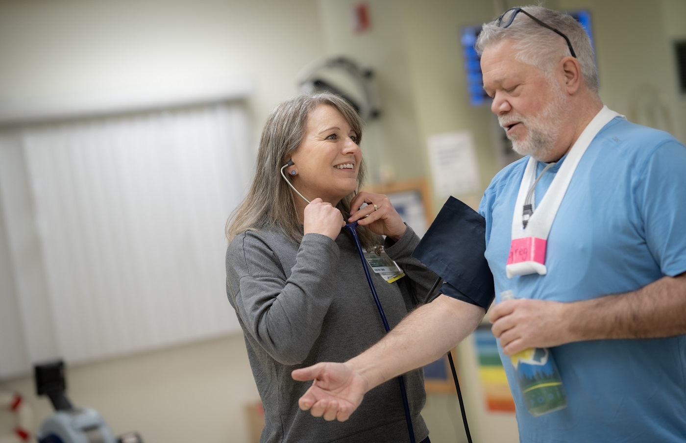 Man being checked by Nurse Kristen Frechette