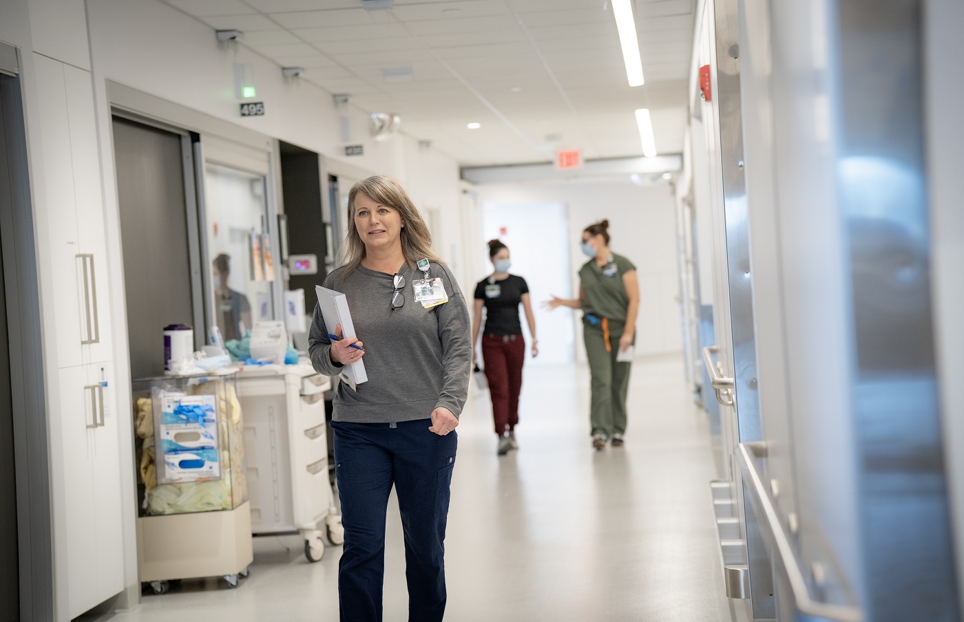 Nurse Kristen Frechette walking down a hall