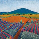 Colorful patterned fields with distant hills.