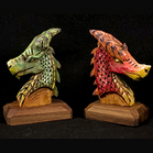 Wooden dragon head sculptures with painted scales