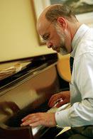 A many playing the Walker Piano at DHMC