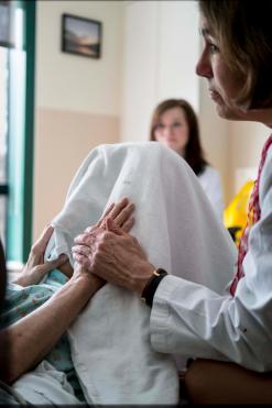 A palliative care provider with a patient and family