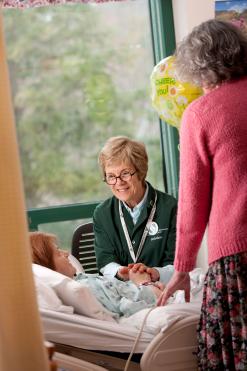 A palliative care volunteer with a patient