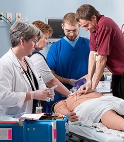 Life support students with simulation patient mannequin