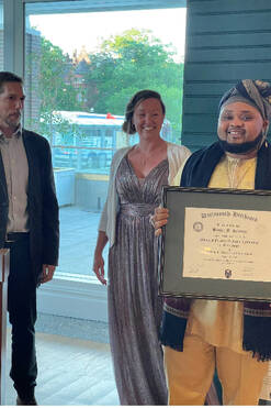 A Neurology APP Fellowship student holding a framed diploma