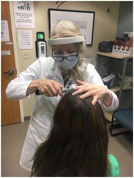 Dr. Pace using tricoscopy to examine a patient's scalp