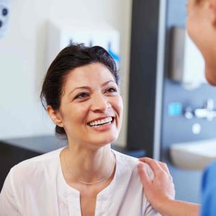 A smiling patient looking at a provider