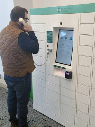 Patient speaking with a pharmacist at a DHMC Prescription locker