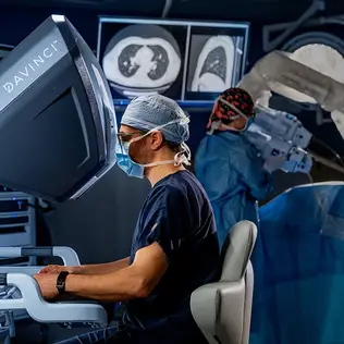 Healthcare provider performing surgery with the DaVinci robotic system