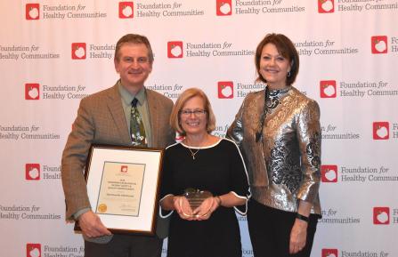 Group photo of award recipients: Chief Quality and Value Officer George Blike, MD; Director of Quality and Safety Lori Key, MBA, RN; and CEO and President Joanne Conroy, MD.