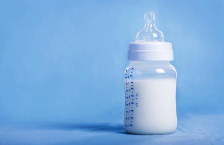Baby bottle on blue background