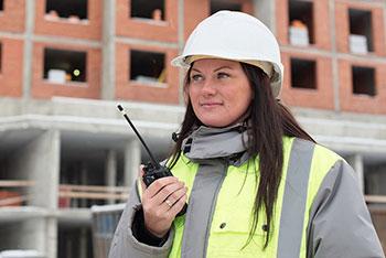 Construction worker at site with walkie-talkie