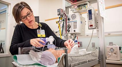 Nurse working with infant Mannikin