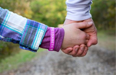 Child holding parent's hand.