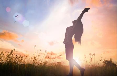 Women standing stress-free in field.