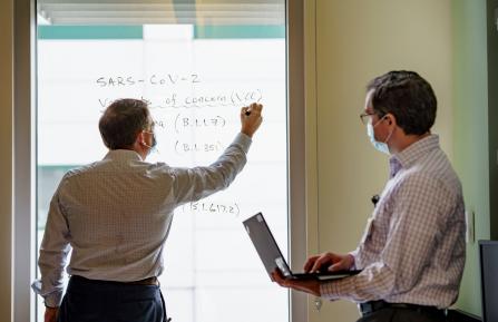 From left to right, Michael L. Whitfield, PhD, and Joel A. Lefferts, PhD, work in the lab.