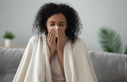black woman with tissue to face