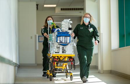 Emily Burnett and Bethany Dewkett transport a patient.
