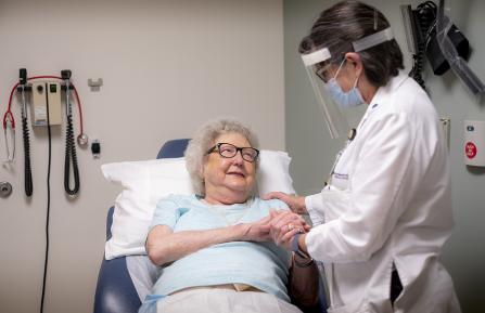 Alison Scully talking with an elderly patient.