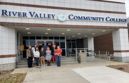 Students in ApprenticeshipNH program stand outside entrance of River Valley Community College