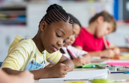 students writing in notebooks