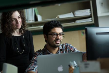 Two researchers looking at a computer screen