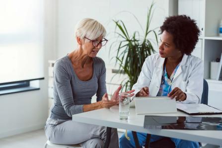 A woman and a provider talking at a table