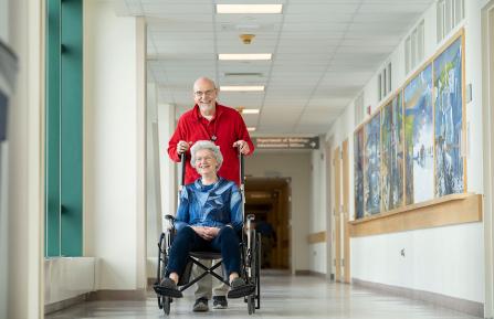 picture of volunteer pushing person in a wheelchair