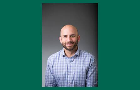 Headshot of Jonathan D. Lichtenstein, PsyD, MBA, on a green background