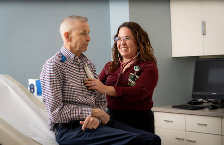 Caitlin I. Booze, MSN, APRN, FNP-BC, with a patient