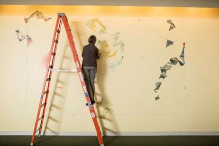 Barbara Garber creating Composition for a Yellow Wall