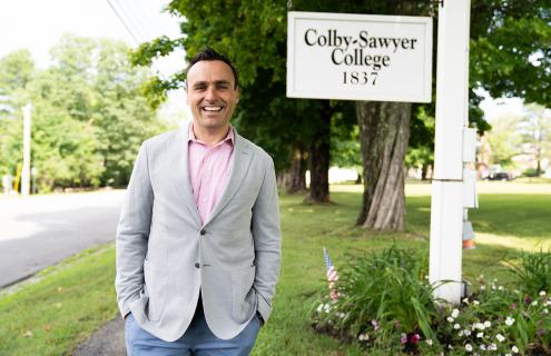 Kevin Finn in front of the Colby-Sawyer College sign
