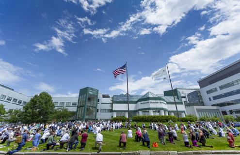 Outside photo of DHMC with providers kneeling