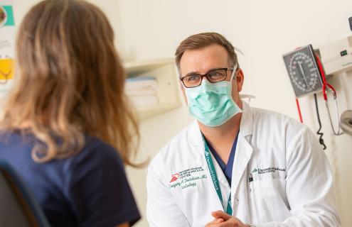 Dr. Dadekian visits with a patient.