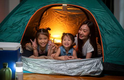 Asian family camping inside