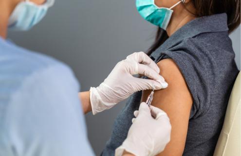Women receiving vaccine shot. 