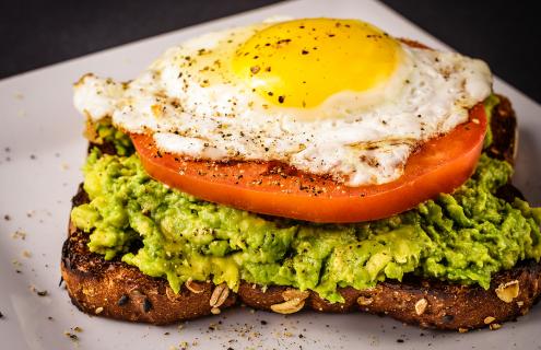 wheat toast with mashed avocado and tomato