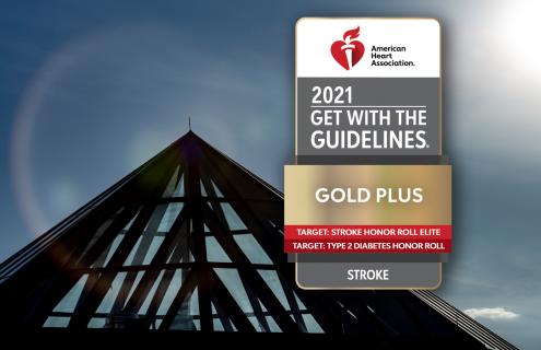  American Heart Association’s Get With The Guidelines®-Stroke Gold Plus Quality Achievement Award badge overlaid on DHMC dome