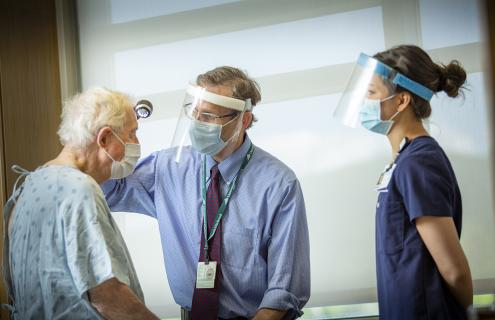 Shane Chapman and student evaluate a patient