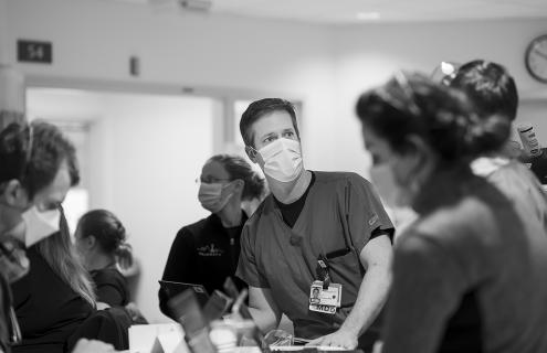 Jeffrey C. Munson, MD, MSCE, is seen working in the Medical Intensive Care Unit of Dartmouth-Hitchcock Medical Center, surrounded by several colleagues.