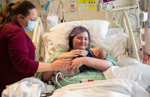 Macenzee Keller holds her baby boy, Zack, with her mother, Brandi Milliner, at her side, in a hospital bed at Dartmouth-Hitchcock Medical Center.