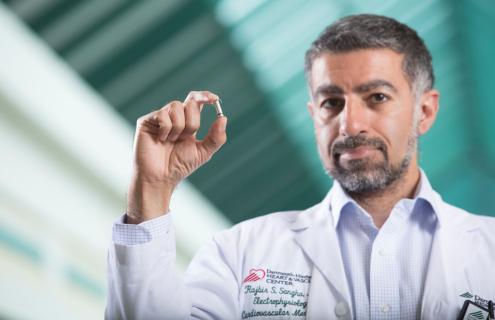 Rajbir S. Sangha, MD, electrophysiologist and D-H Device Clinic medical director, holds a cardiovascular implantable electronic devices (CIED).