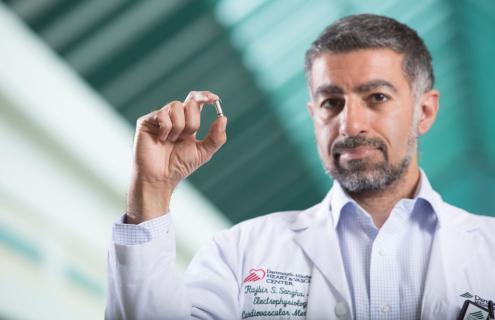 Rajbir S. Sangha, MD, electrophysiologist and D-H Device Clinic medical director, holds a cardiovascular implantable electronic devices (CIED).
