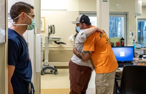 Mark McEnnis embraces Dartmouth Hitchcock Medical Center nurse Samantha E. Daniels, RN, who was part of the care team who saved his life.