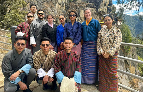 Doctors pose along mountainside in traditional Bhutanese garb