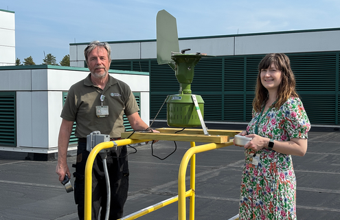 DHMC Mechanical Engineering Supervisor Bruce Spencer with DHMC Allergist Erin Reigh, MD, MS, in front of a pollen-counting station.