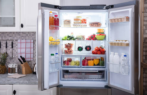 A refrigerator with its doors open.
