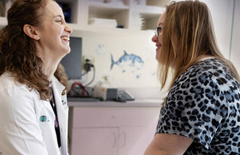 Pediatric Dermatologist Jillian Rork, MD, laughing with a patient