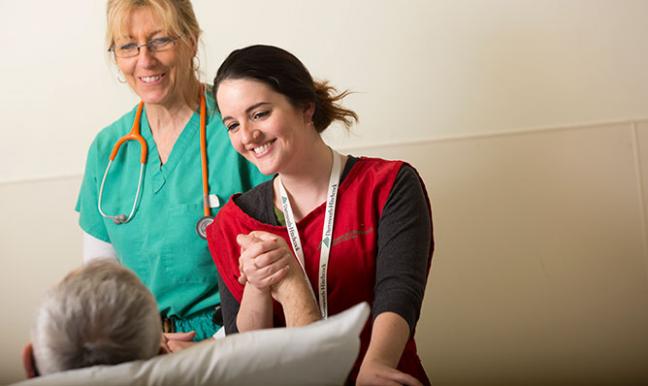 A volunteer and provider with a patient