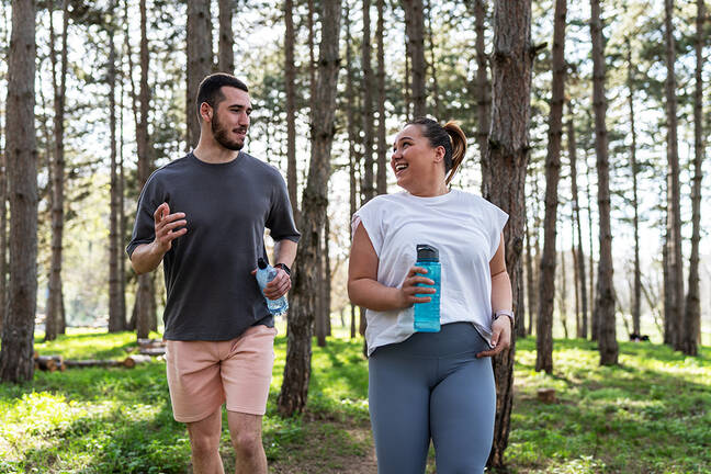 Weight Center: Healthy lifestyles, man and woman jogging in a wooded park